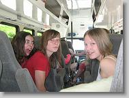 Ashlee, Lydia, and Hannah in the bus fooling around.