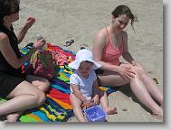 Ms. Dawn, Ms. Jill, and cute little Bailey (Ms. Dawn's daughter) playing in the sand.