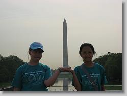 Ciara and Eun-Ji holding up the Washington Monument.