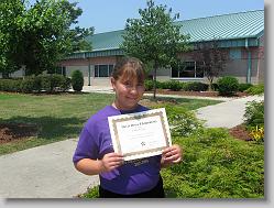 Ciara and her 5th grade diploma, outside Davis Drive Elementary
