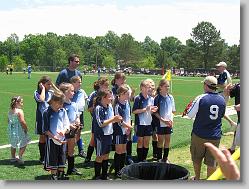 Coach handing in the medals.