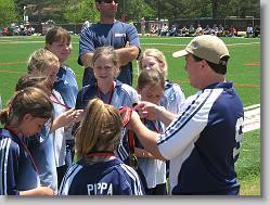 Coach handing in the medals.