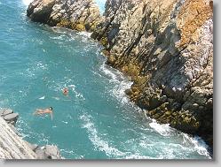 Swimming across to climb up the cliffs on the other side...