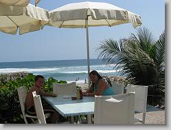 Joshua and Ciara by the pool, overlooking the ocean.