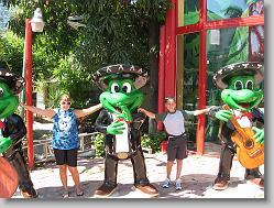 Ciara and Joshua posing with the frogs at the Senor Frogs store.